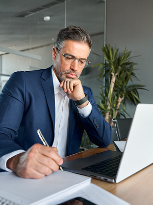 man with a pen and laptop computer