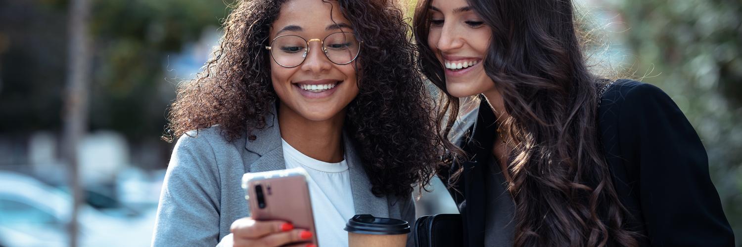 two women looking at a phone